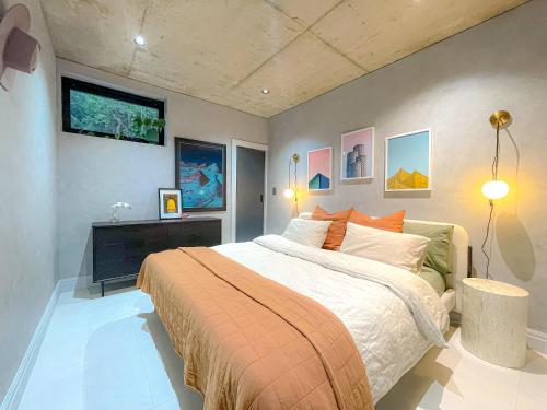 a bedroom with a bed and a tv on the wall at Adelaide Hills Underground in Bridgewater