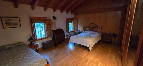 a bedroom with a bed and a wooden floor at Casa Renacimiento in Coín