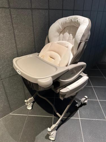 a white high chair sitting in a room at hotel tou nishinotoin kyoto in Kyoto