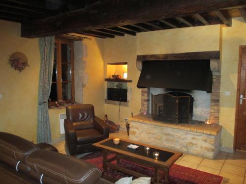 a living room with a couch and a fireplace at Holiday Home in Isenay near Lake and Forest in Isenay