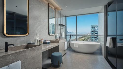 a bathroom with a large tub and a large window at Crowne Plaza Hangzhou Riverside by IHG in Hangzhou