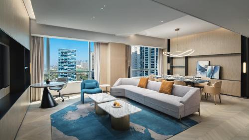 a living room with a couch and a table at Crowne Plaza Hangzhou Riverside by IHG in Hangzhou