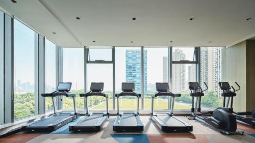 a gym with a bunch of treadmills in a building at Crowne Plaza Hangzhou Riverside by IHG in Hangzhou