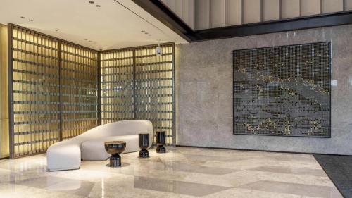 a lobby with a white chair and a large window at Crowne Plaza Hangzhou Riverside by IHG in Hangzhou
