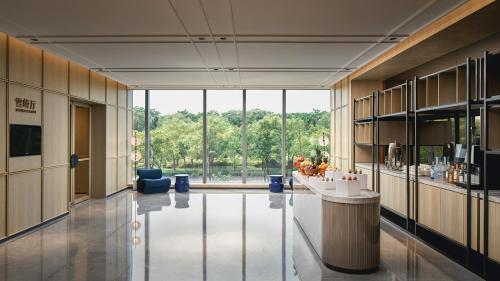 a large lobby with a large window in a building at Crowne Plaza Hangzhou Riverside by IHG in Hangzhou