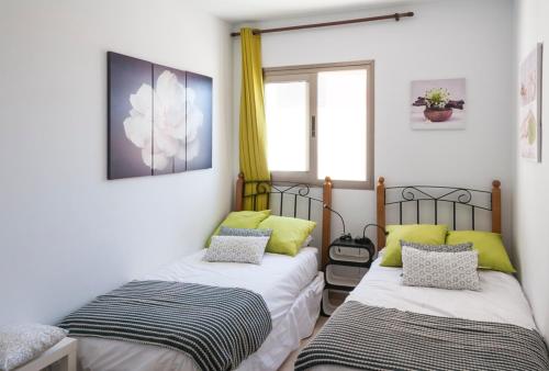 two beds sitting next to each other in a room at Apartment Poris Sunrises in Poris de Abona