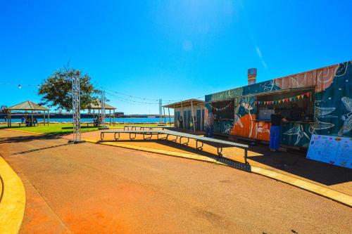 a building with graffiti on it next to a street at Elated Edgar 2x1 Close to CBD in Port Hedland