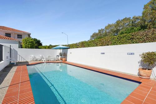 a swimming pool in the backyard of a house at Villa Aqua 6 - Riverfront Noosaville in Noosaville