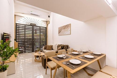 a dining room with a wooden table and chairs at The Hammond Saigon 3 in Ho Chi Minh City