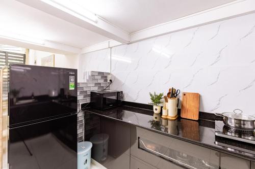 a kitchen with a black and white counter top at The Hammond Saigon 3 in Ho Chi Minh City