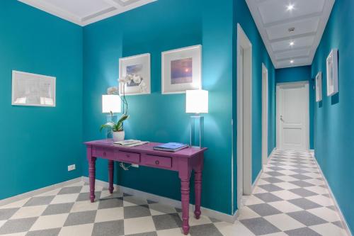 
a blue and yellow room with a blue wall at Hotel Moderno in Trapani
