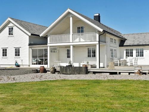 a white house with a picnic table in front of it at 10 person holiday home in Tornes I Romsdal in Tornes