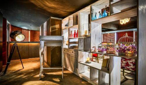 a room with a table and shelves with vases at T24 Residency Mumbai International Airport Hotel in Mumbai