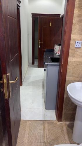 a bathroom with a sink and a toilet in a room at رمال العلا 1 Sand AlUla 1 in Quai