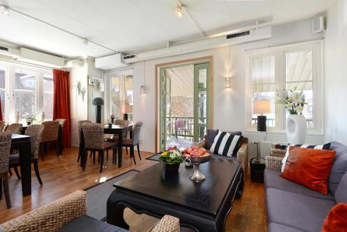 a living room with a couch and a table at Maude´s Hotel Enskede Stockholm in Stockholm