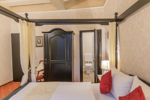 a bedroom with a bed with a black door at Hotel Weiler in Oberwesel