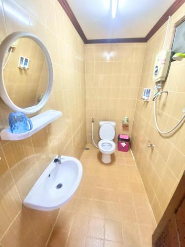 a bathroom with a sink and a toilet and a mirror at Luangprabang Suankeo boutique Villa in Luang Prabang