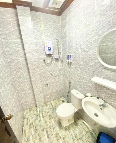 a bathroom with a toilet and a sink at Luangprabang Suankeo boutique Villa in Luang Prabang