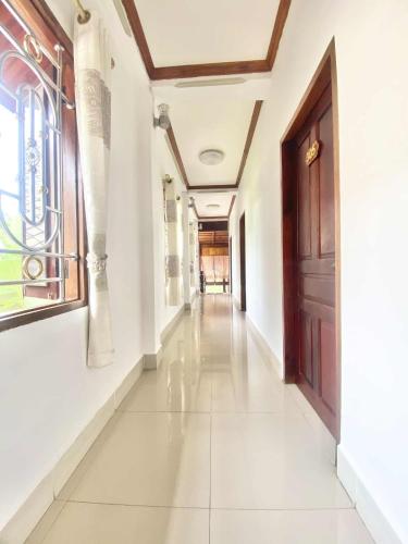a corridor of a building with a door and a hallway at Luangprabang Suankeo boutique Villa in Luang Prabang