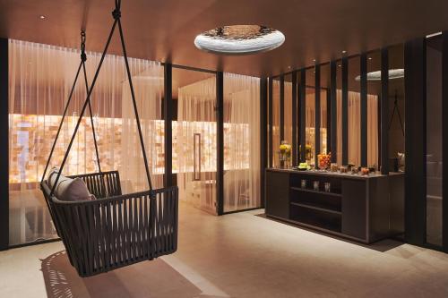 a swinging chair in a room with a bar at SCHLOSS Zermatt - CBD & Adaptogenic Spa and Sport Hotel in Zermatt