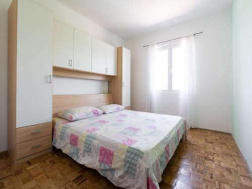 a small bedroom with a bed and a window at Simplistic Holiday Home in Rogoznica near the Seabeach in Rogoznica