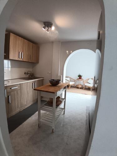 a kitchen with a table in the middle of a room at La Casa de Gigi in Nerja