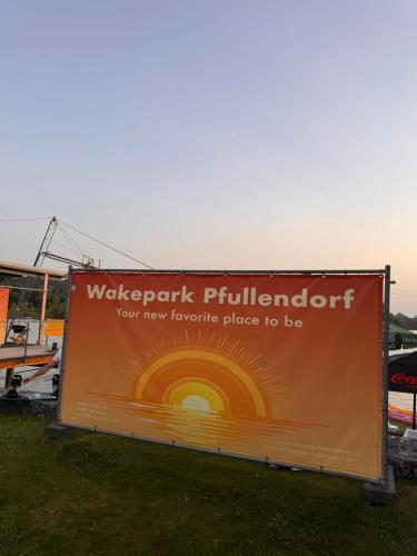 a large billboard sign in the grass at Gemütliche, sonnendurchflutete Ferienwohnung in Bodenseenähe am Säntisblick in Herdwangen-Schönach