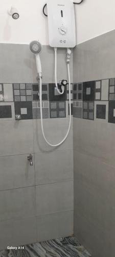 a bathroom with a shower with a shower head at The Max Villa in Negombo