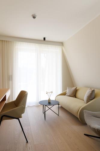 a living room with a couch and a table at Weinlandhof in Gamlitz
