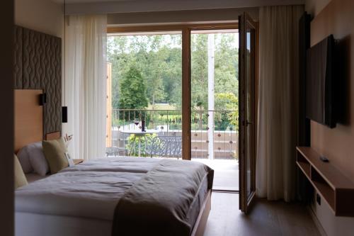 a bedroom with a bed and a sliding glass door at Weinlandhof in Gamlitz
