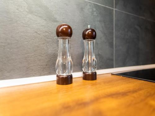 two glass bottles sitting on top of a table at Holiday Home in Bullingen with Garden in Bullange