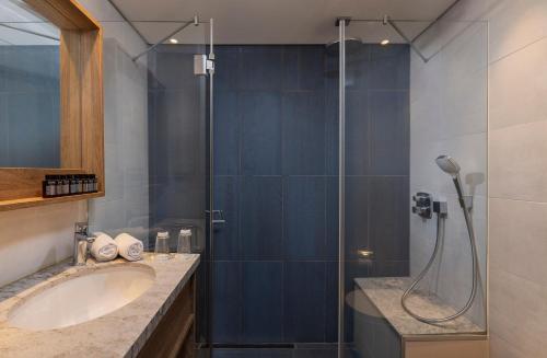 a bathroom with a sink and a shower at King Solomon Hotel Tiberias in Tiberias