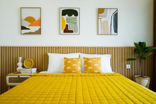 a bedroom with a large yellow bed with pillows at Charming cozy House in Yogya, 15Min from Prambanan in Kalasan