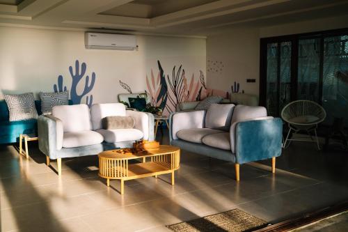 a living room with two chairs and a couch and a table at Barali Beach Resort Koh Chang in Ko Chang