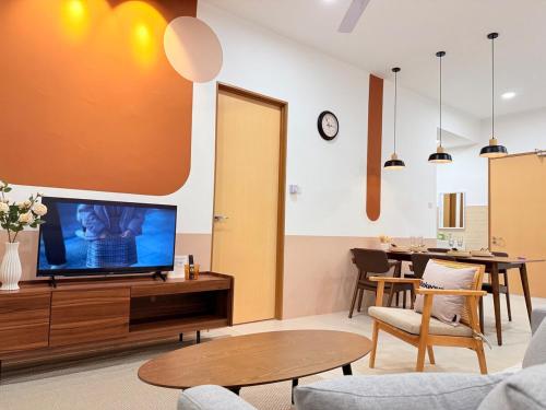 a living room with a tv and a table at Jeff & Ricky Homestay143-Kenny Hiil Residence in Kuching
