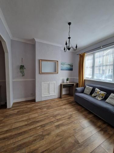a living room with a couch and a table at 3-Bed Home, Garden, Free Parking,Greater London in Erith