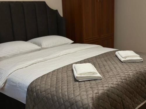 a bed with two towels on top of it at 2-к квартира в Черновцах in Chernivtsi
