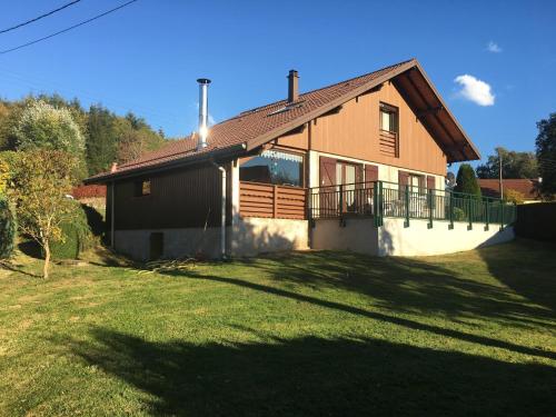 a house with a large yard in front of it at Elegant Chalet in Gerbépal in cosy environment in Gerbépal