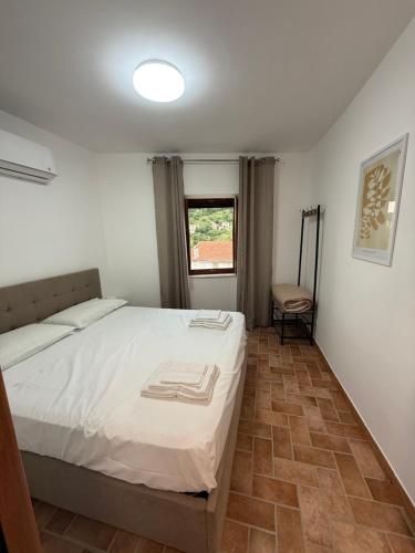 a bedroom with a white bed and a window at B&B Colle Alto in Carovilli