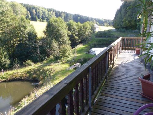 a wooden walkway with a view of a river at Alluring Apartment in Schönsee in the forest in Schönsee