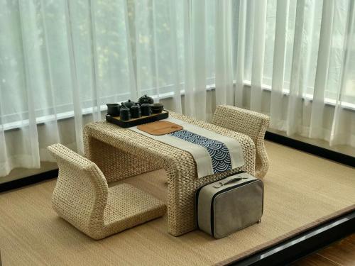 a table and two chairs and a suitcase on a table at Songshan Lake Minshu Villa 