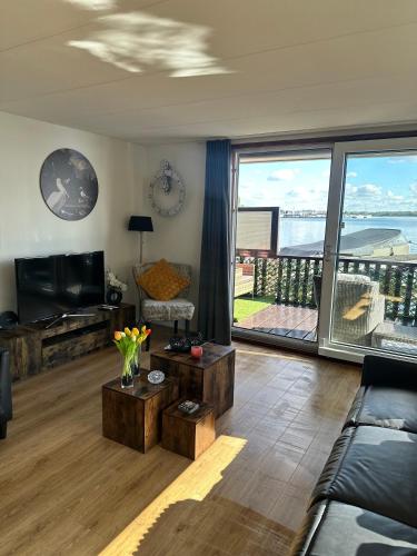 a living room with a view of the ocean at Woonboot De Witte loosdrechtse plassen in Loosdrecht