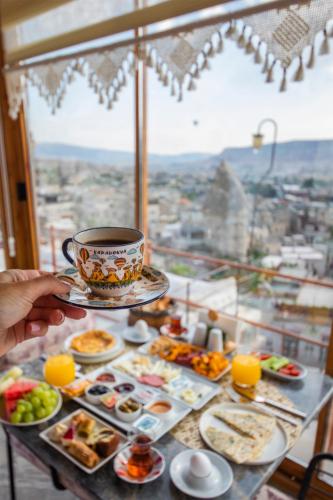 a table with plates of food and a cup of coffee at Charming Cave Hotel in Goreme