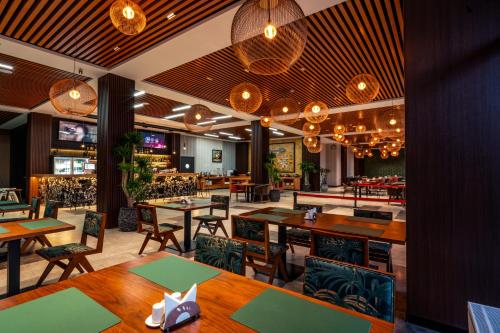 a restaurant with tables and chairs and a bar at Blue Spot Resort in Yoliin Hural