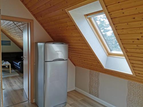 a refrigerator in a room with a window at Spacious appartment in Wilhelmshof near Lake in Wilhelmshof