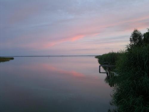 a view of a lake at sunset at Spacious appartment in Wilhelmshof near Lake in Wilhelmshof