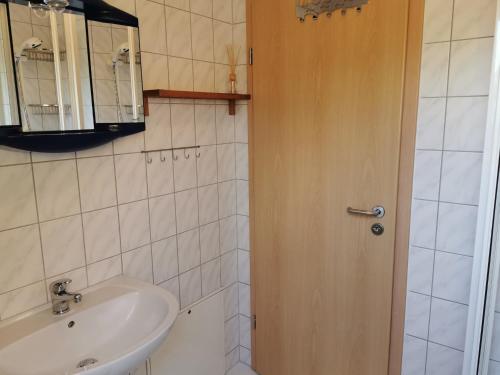 a bathroom with a sink and a mirror at Spacious appartment in Wilhelmshof near Lake in Wilhelmshof