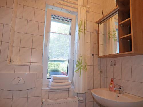a bathroom with a sink and a window at Spacious appartment in Wilhelmshof near Lake in Wilhelmshof