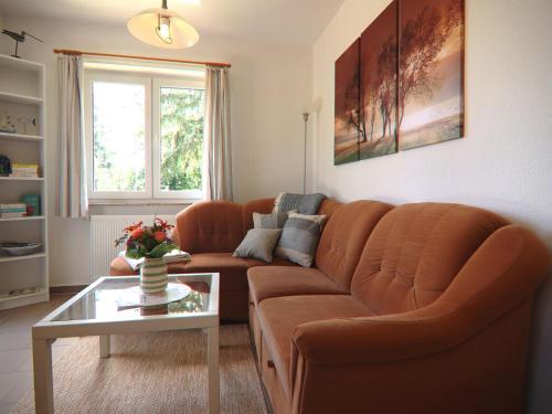 a living room with a couch and a table at Spacious appartment in Wilhelmshof near Lake in Wilhelmshof