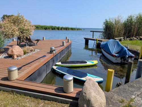 a dock with a bunch of boats on the water at Spacious appartment in Wilhelmshof near Lake in Wilhelmshof